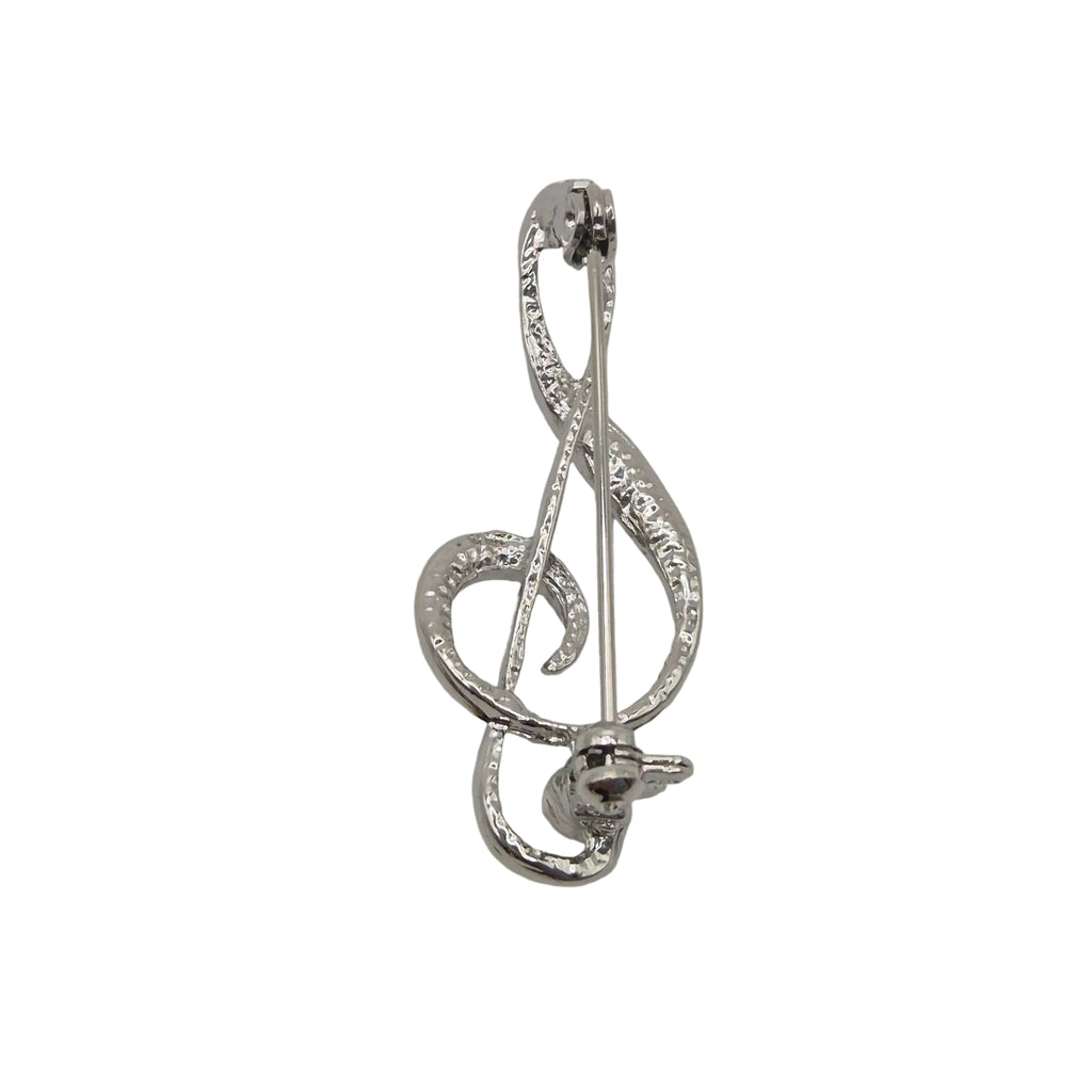 A silver-tone metal pin shaped like a treble clef, photographed on a plain white background.