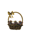 Brooch with birds in a basket and a gold bow on a white background