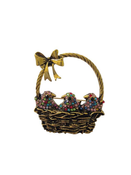 Brooch with birds in a basket and a gold bow on a white background