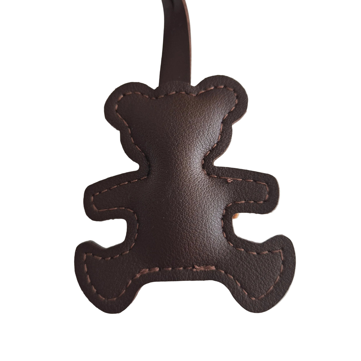 A dark brown leather keychain or bag charm shaped like a teddy bear with visible contrast stitching and a matching leather loop, shown on a plain white background.