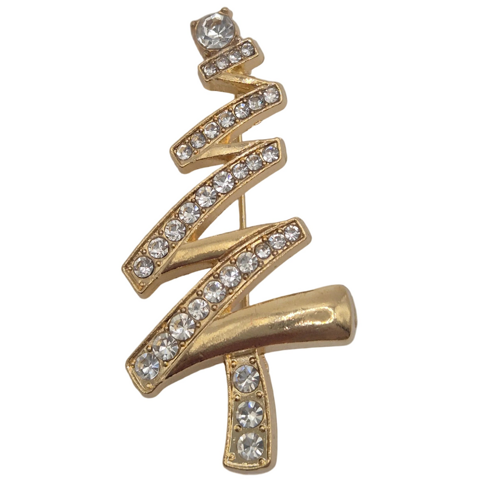 A gold Christmas tree-shaped brooch or pin embellished with clear rhinestones, shown against a plain white background.