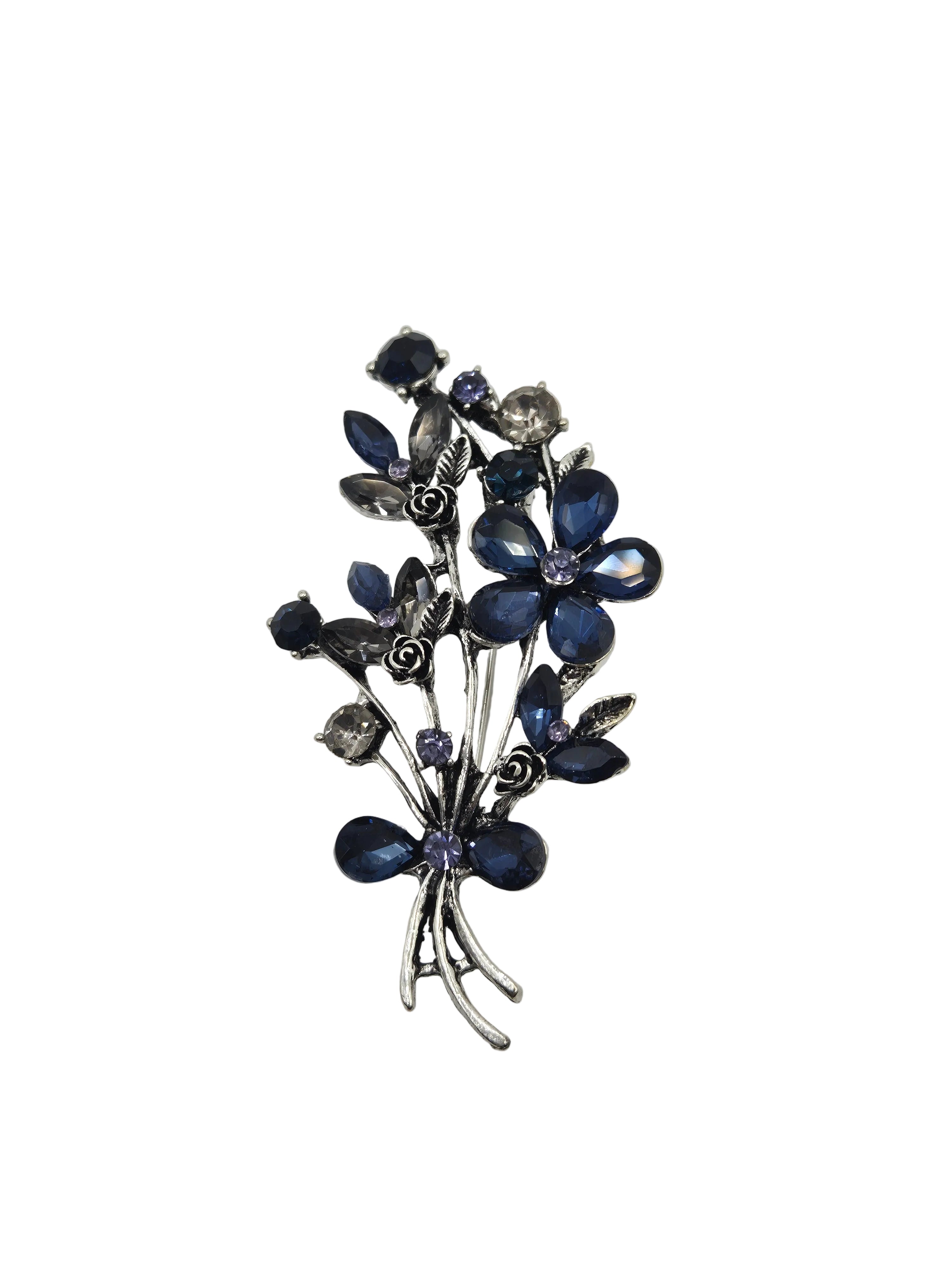 Floral brooch with blue stones on a gray background