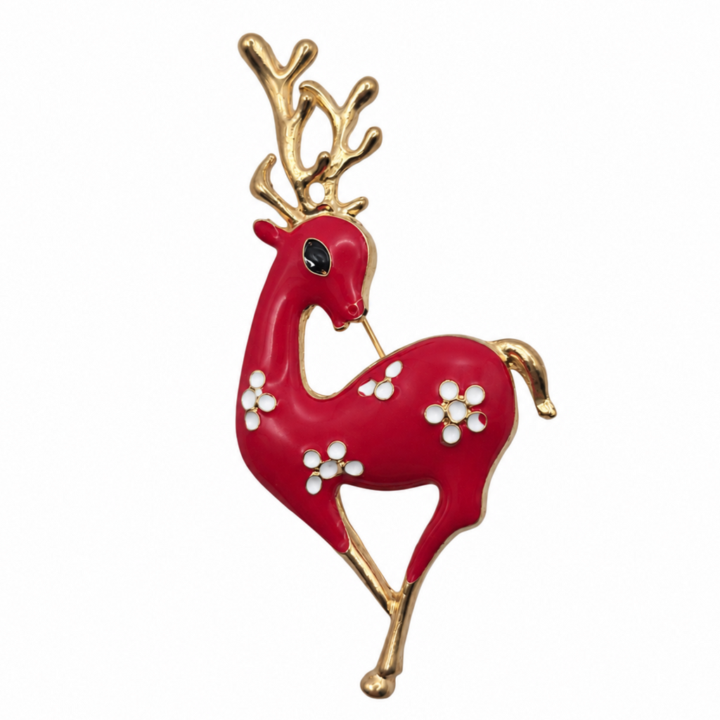 A red and gold reindeer brooch with white flower accents and a small black eye, shown on a plain white background.