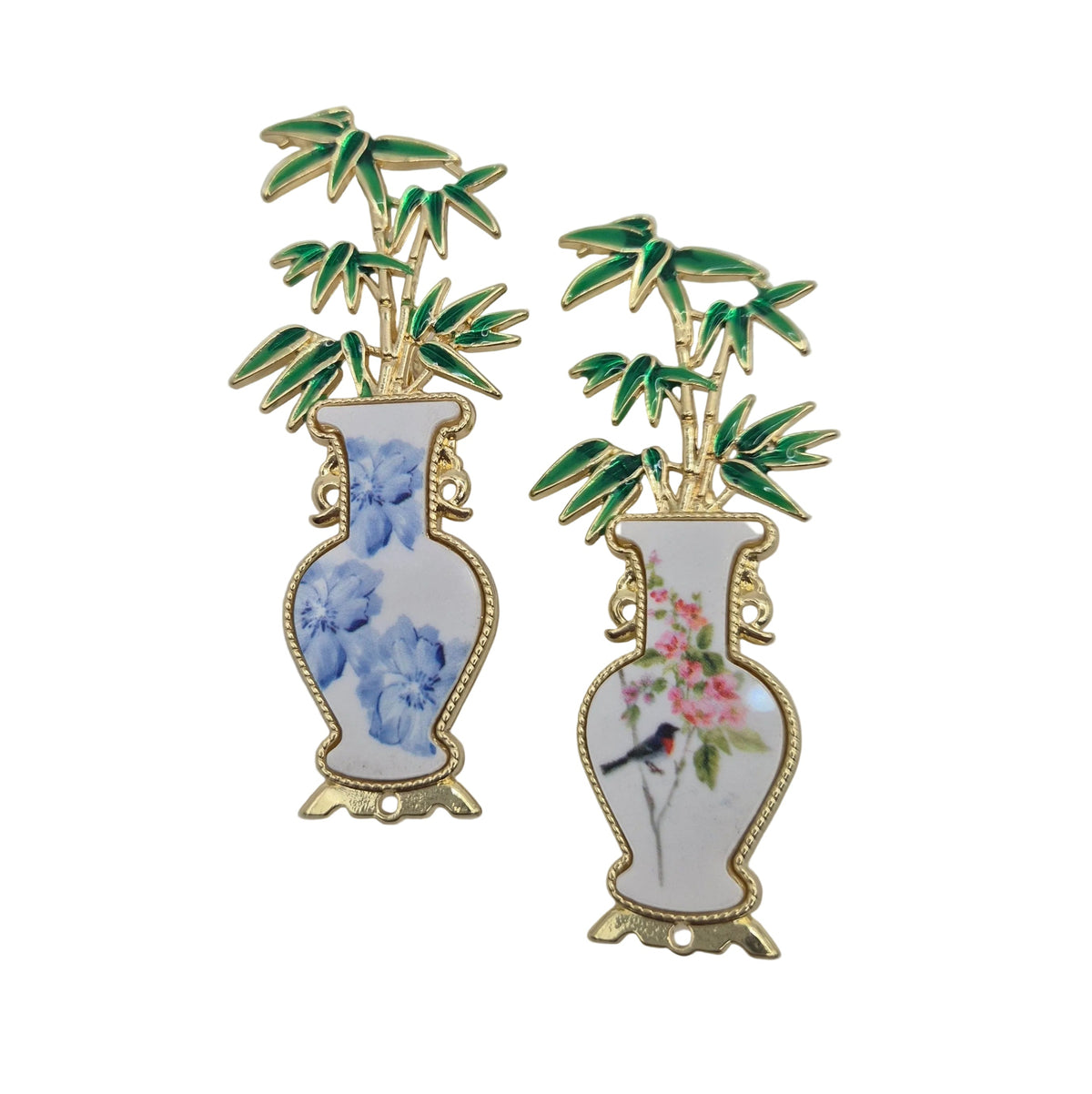 Two decorative enamel pins shaped like white porcelain vases with bamboo and floral designs, displayed on a plain white background.