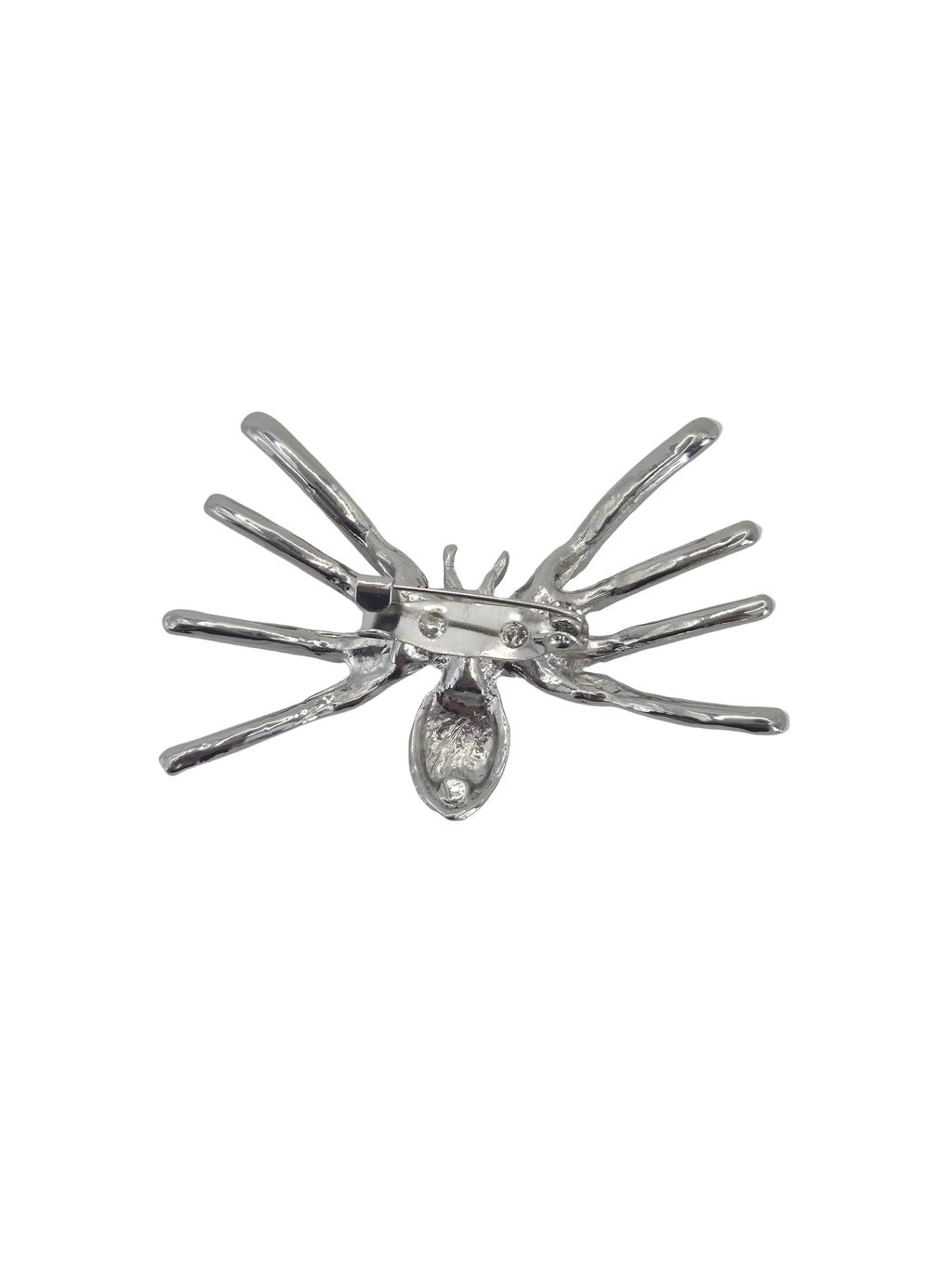 A silver spider brooch on reverse side set against a plain white background.