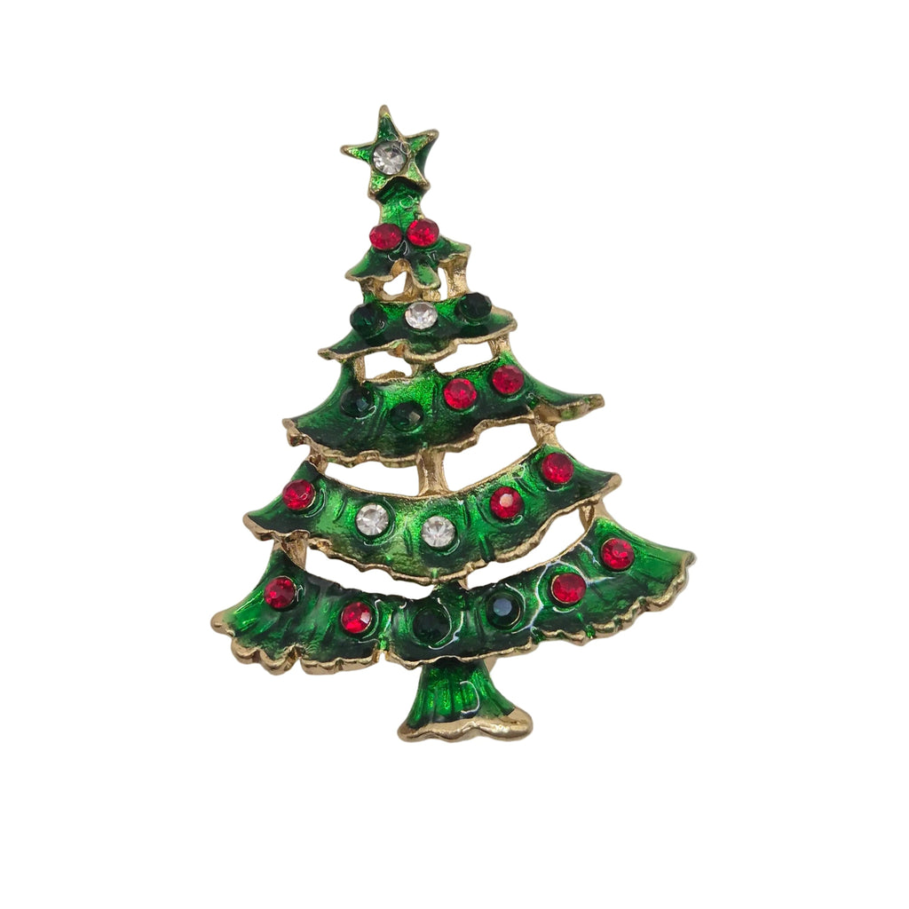 A Christmas tree-shaped brooch with green enamel, gold-tone metal trim, and red and clear rhinestone embellishments, shown on a plain white background.