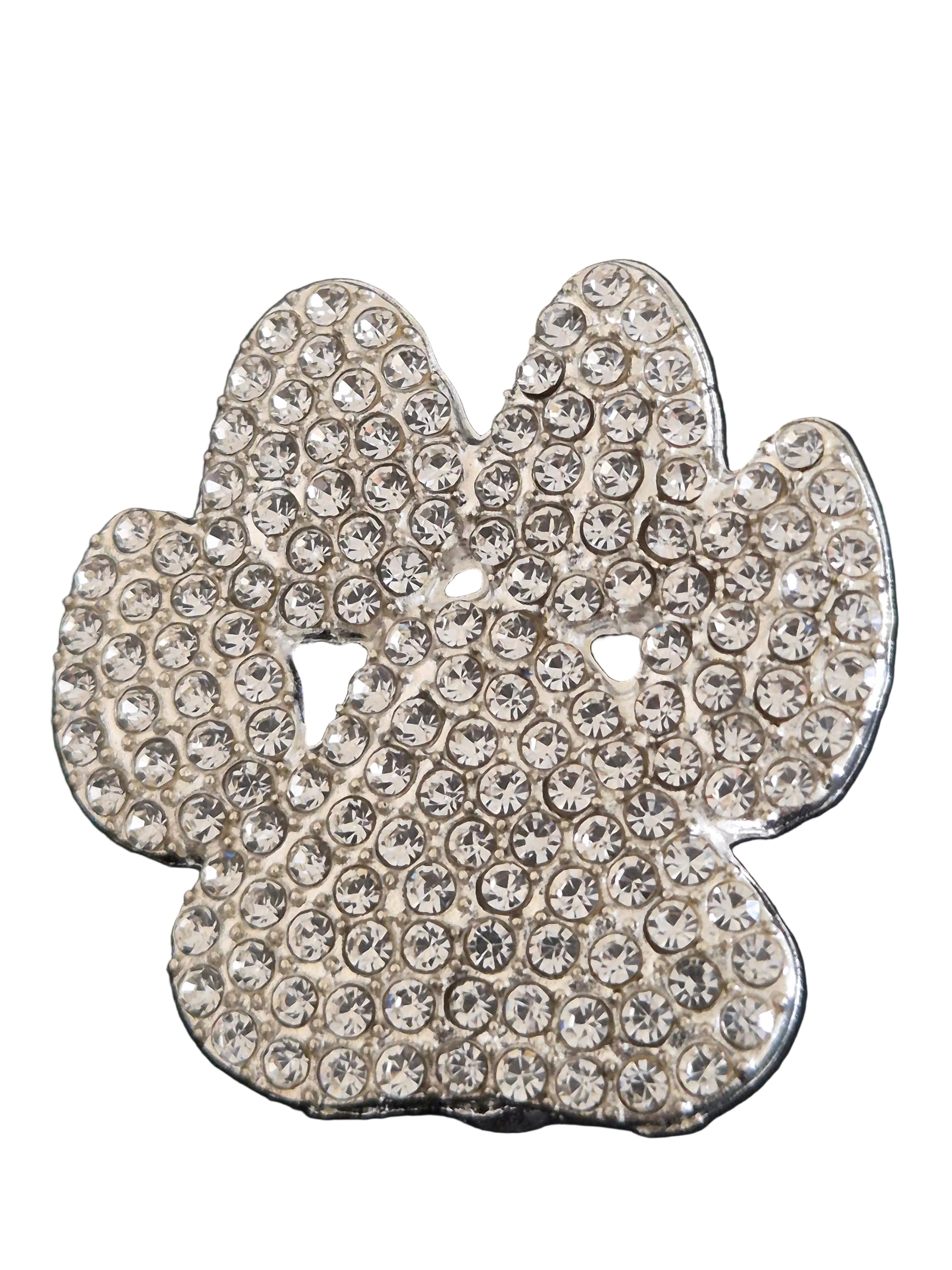 Decorative paw print brooch with rhinestones on a white background