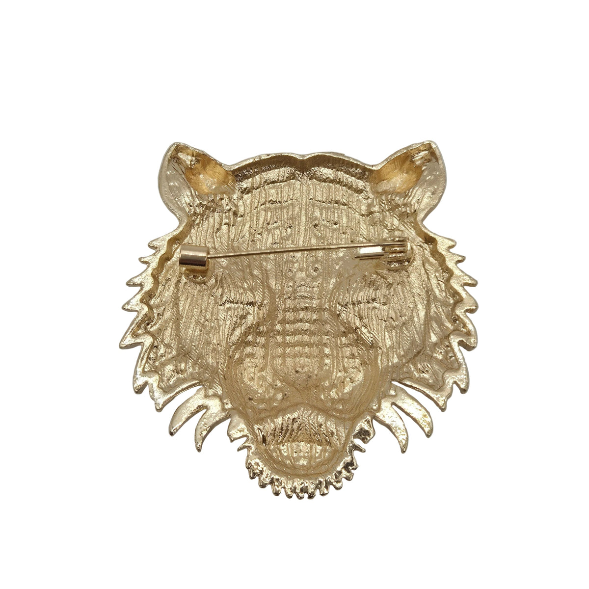 A gold-colored tiger head brooch with a textured, engraved surface and a pin clasp on the underside, shown against a plain white background.