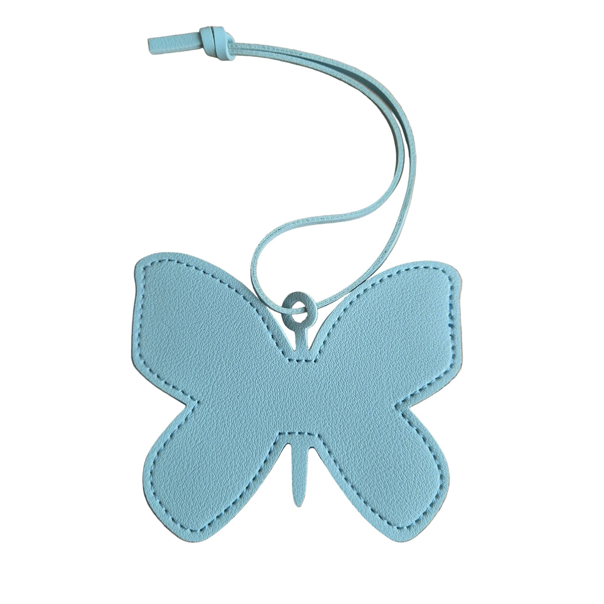 A light blue faux-leather butterfly-shaped bag charm with a matching loop strap, placed on a plain white.