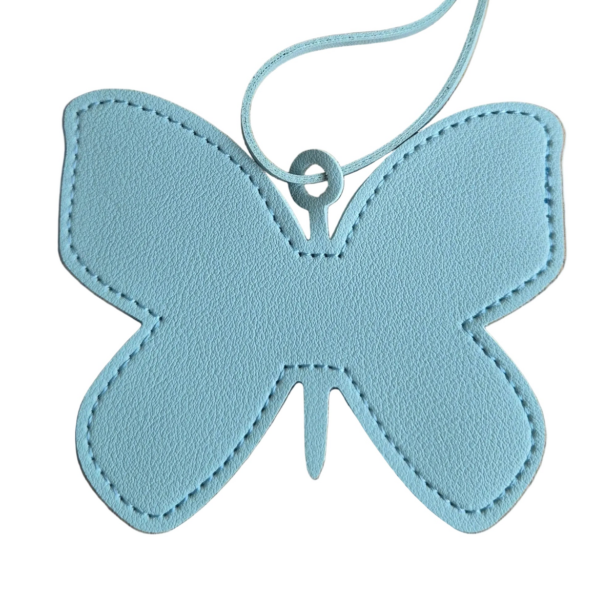 A light blue butterfly-shaped leather bag pendant with a matching loop strap, shown on a plain white background.