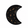 A crescent moon-shaped black tray decorated with metallic rose gold star and dot patterns, shown against a plain white background.