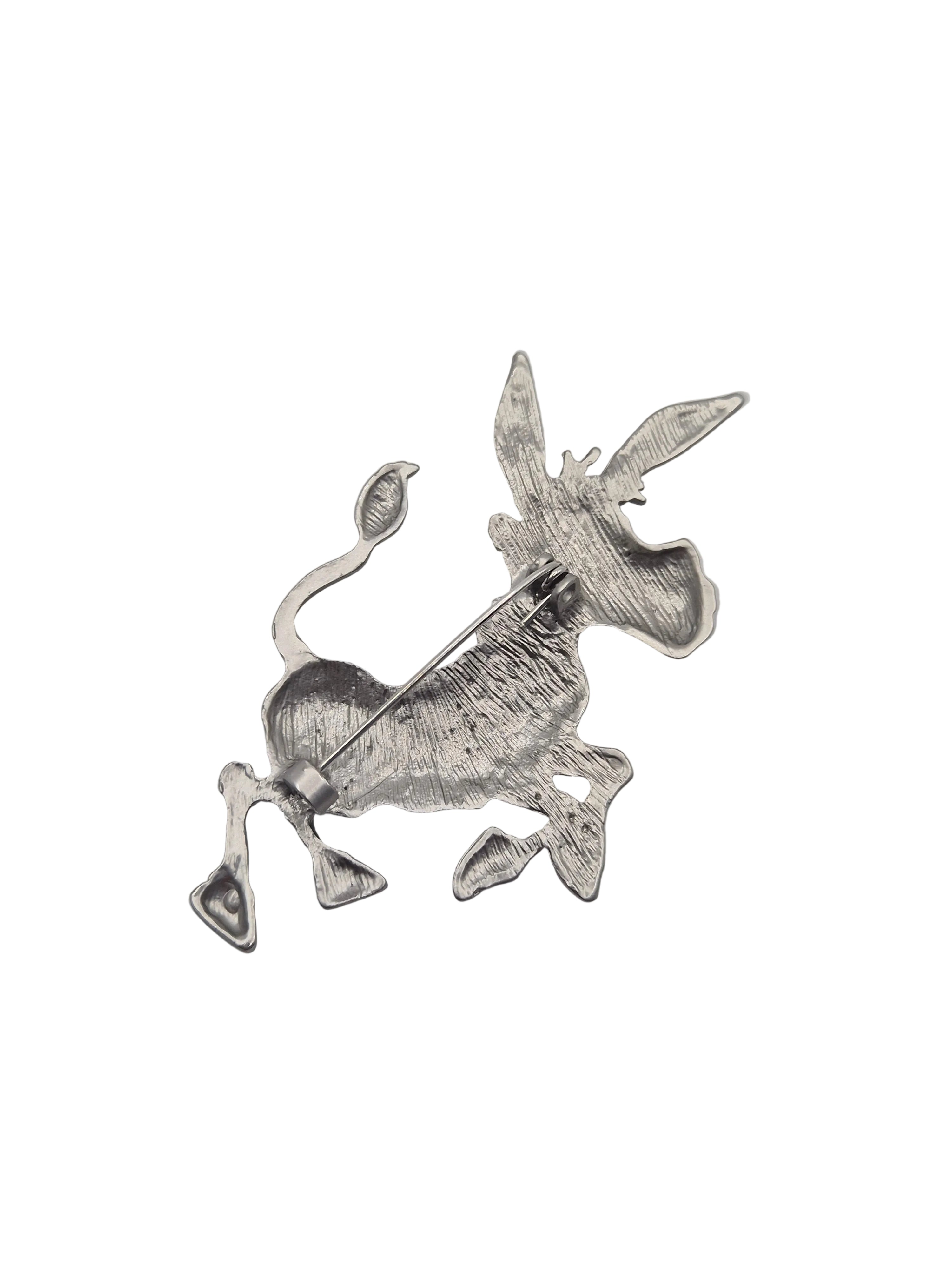 A silver-toned metal donkey pin brooch with a textured, hammered finish, shown on a plain white background.