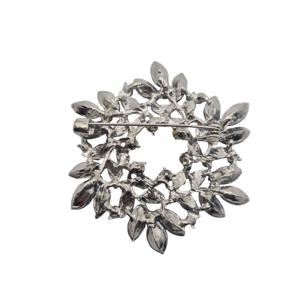 Blue and silver wreath brooch reverse side on white background