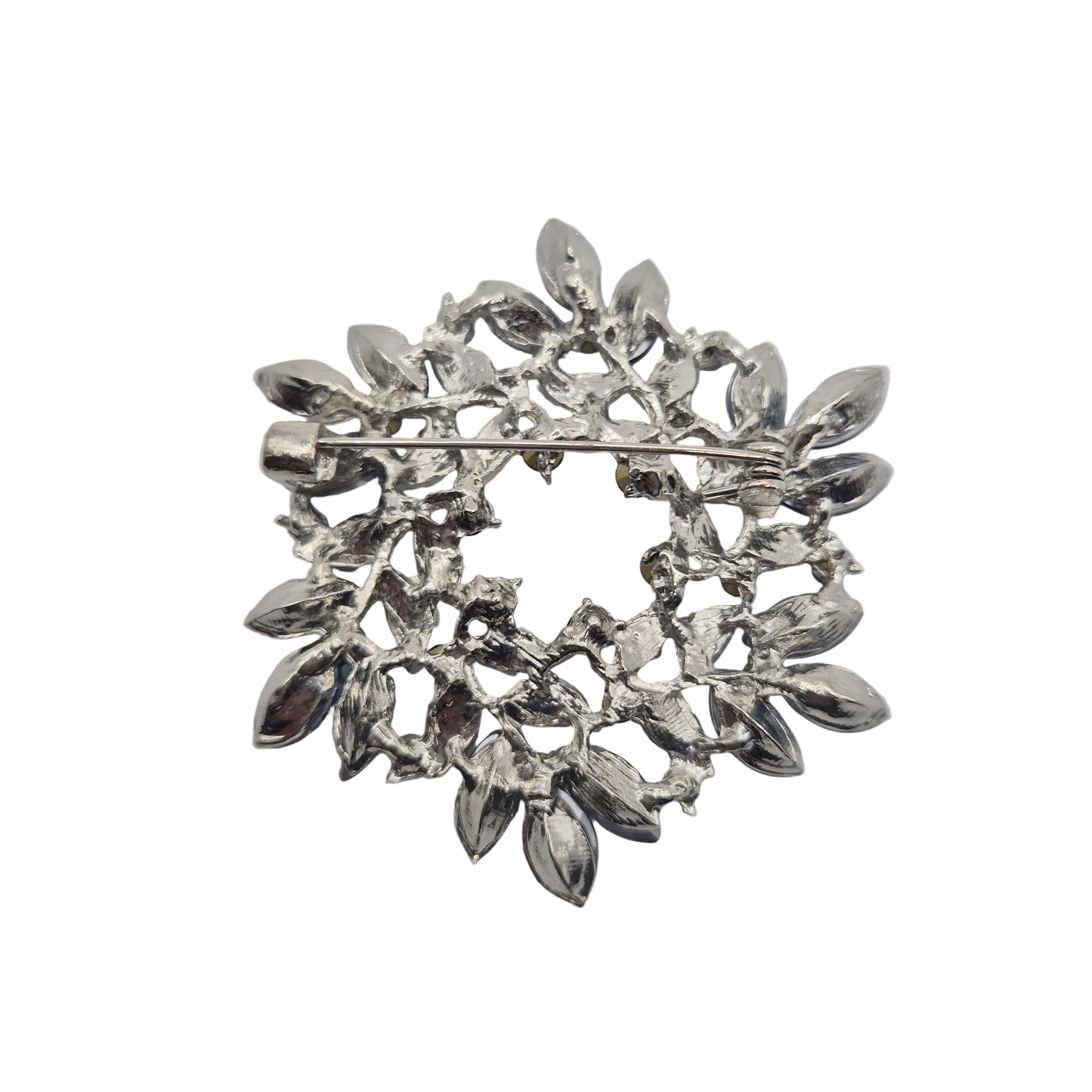Blue and silver wreath brooch reverse side on white background