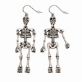 Pair of silver-tone skeleton drop earrings with detailed skulls, ribcages and jointed limbs, shown from the front on a white background.