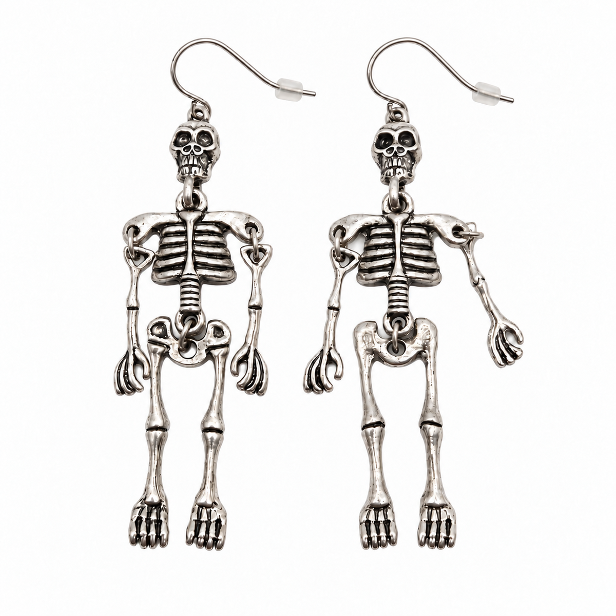 Pair of silver-tone skeleton drop earrings with detailed skulls, ribcages and jointed limbs, shown from the front on a white background.