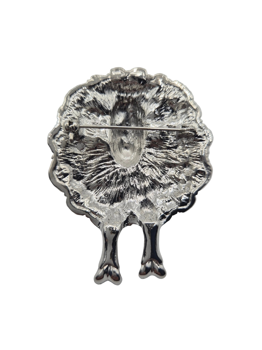 Sheep brooch with a textured design on a white background