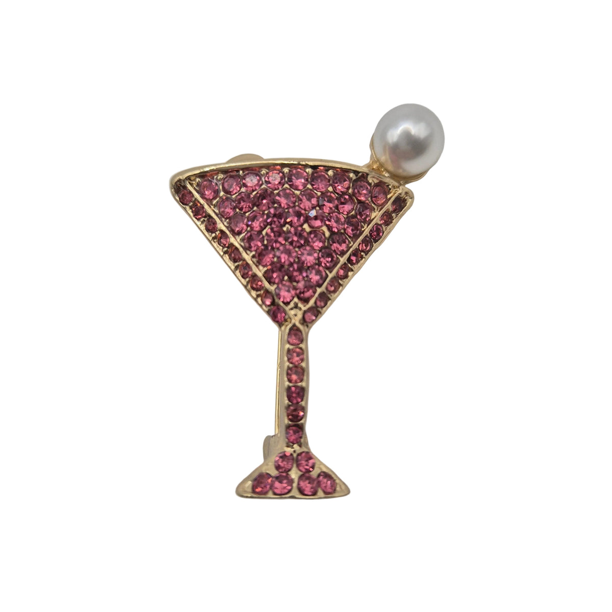 A gold-toned cocktail martini glass brooch embellished with pink rhinestones and topped with a single white faux pearl, shown on a plain white background.