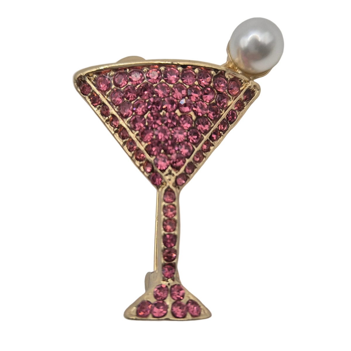 A gold-tone cocktail martini glass brooch decorated with pink rhinestones and topped with a single white faux pearl, shown on a plain white background.