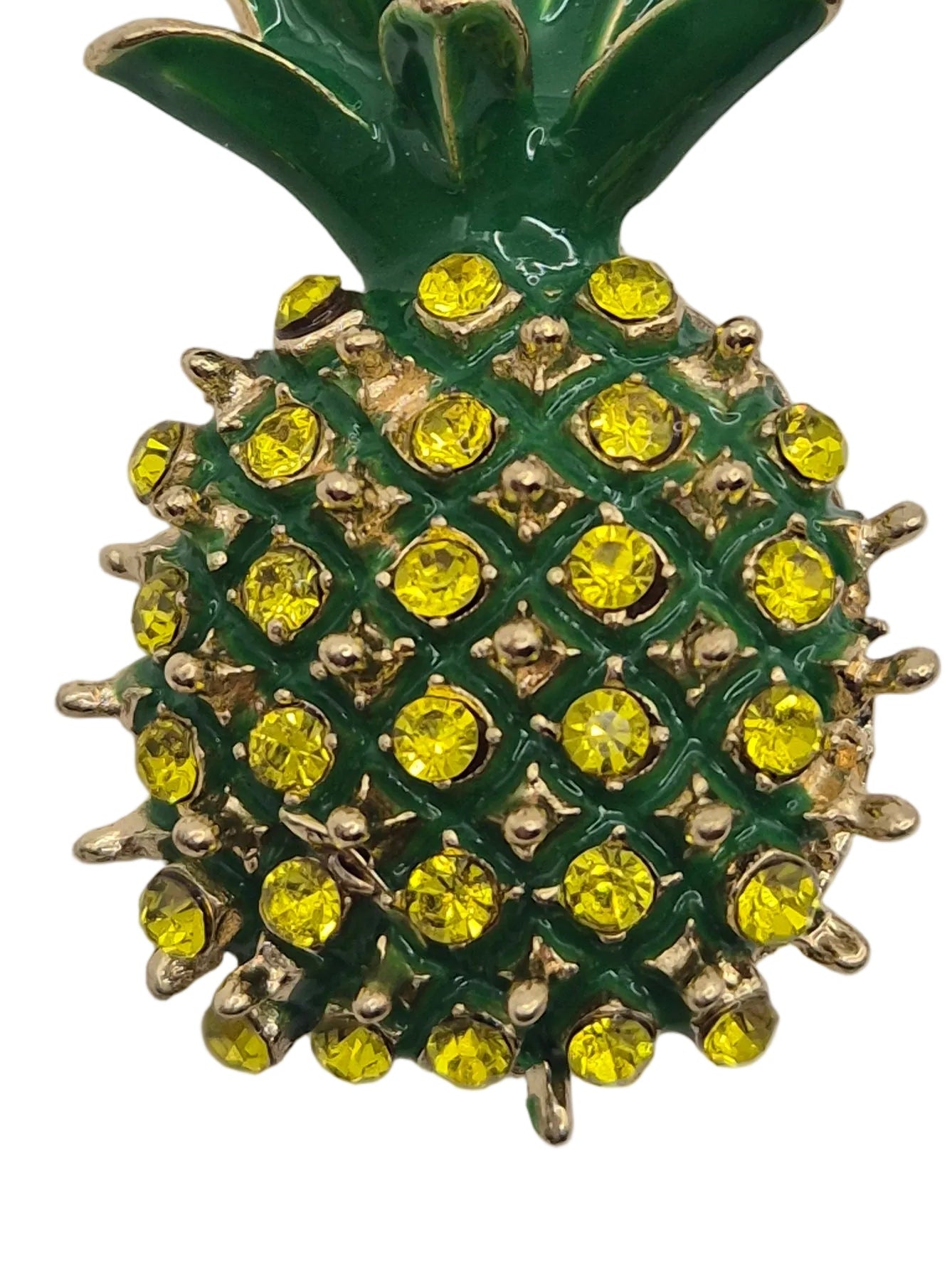 Pineapple-shaped brooch with green and yellow rhinestones on white background