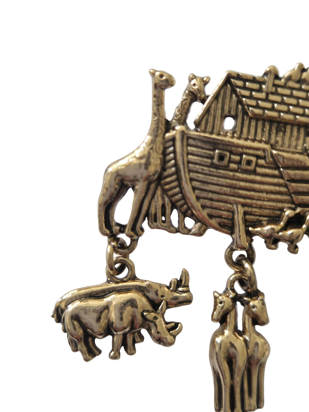 gold-colored brooch with a house and animal pendant on a white background