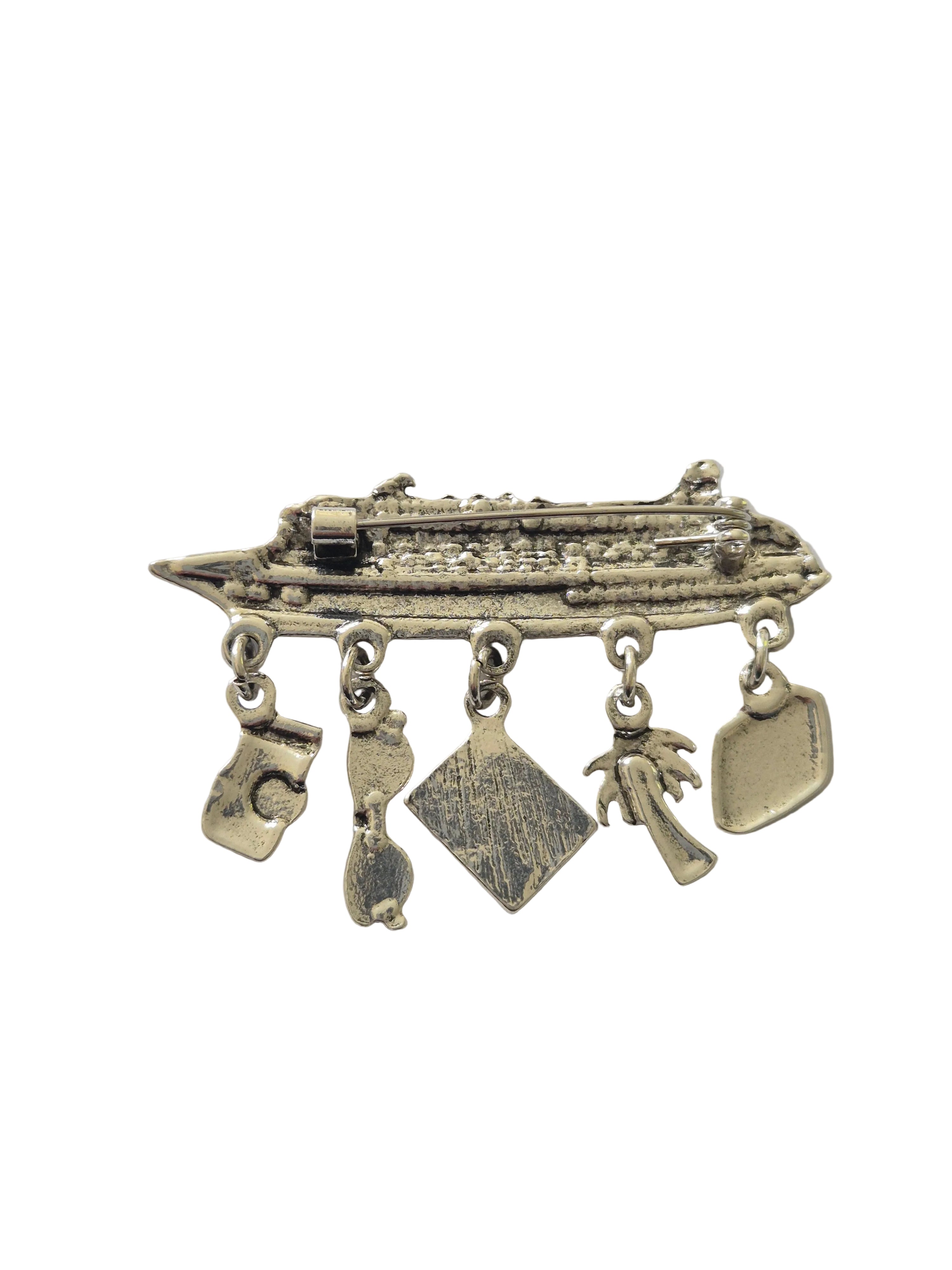 Silver brooch with multiple pendants on a white background