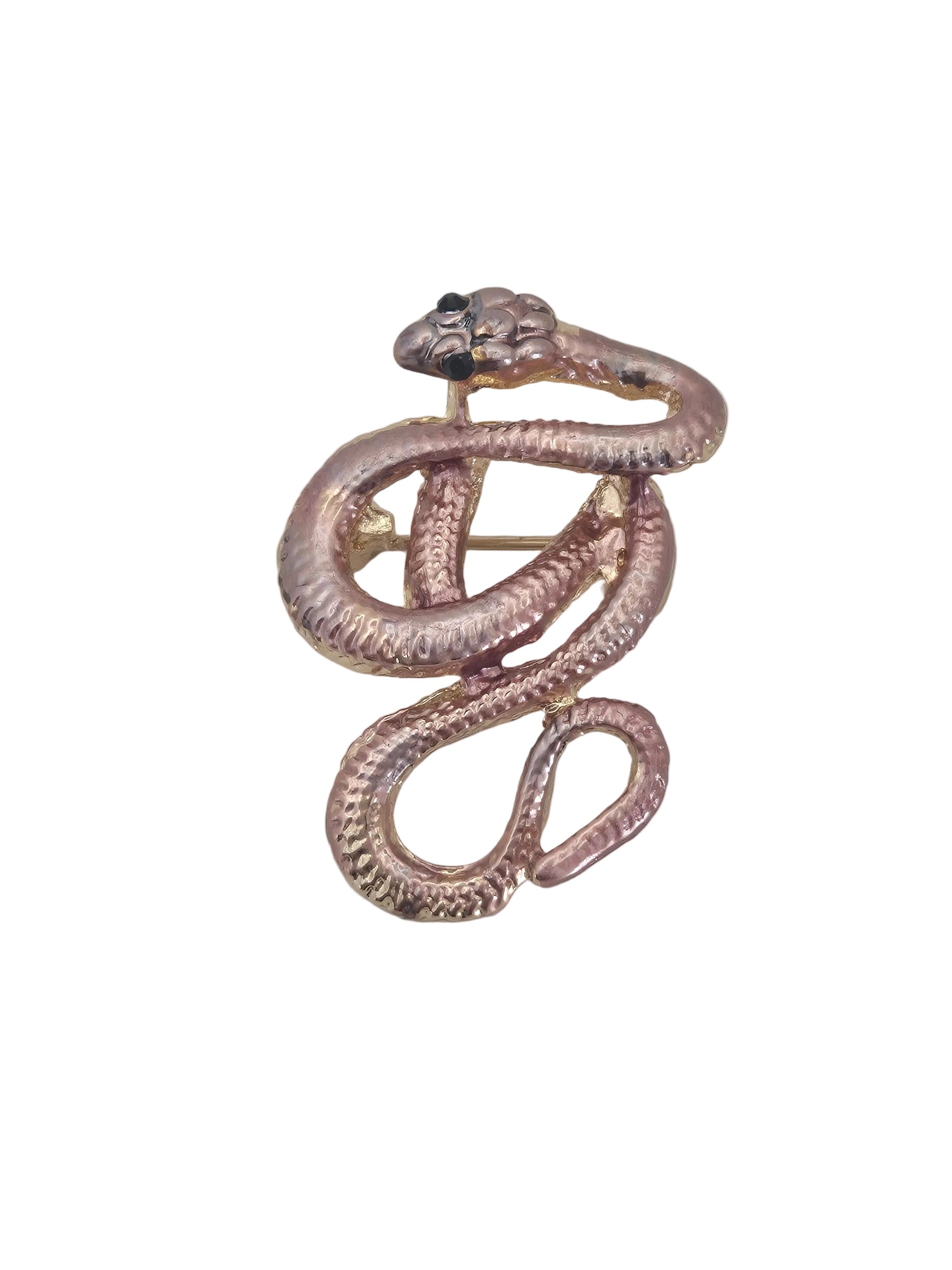 A snake-shaped brooch in a warm rose gold tone, coiled in a spiral form with a small black eye detail, shown on a plain white background.