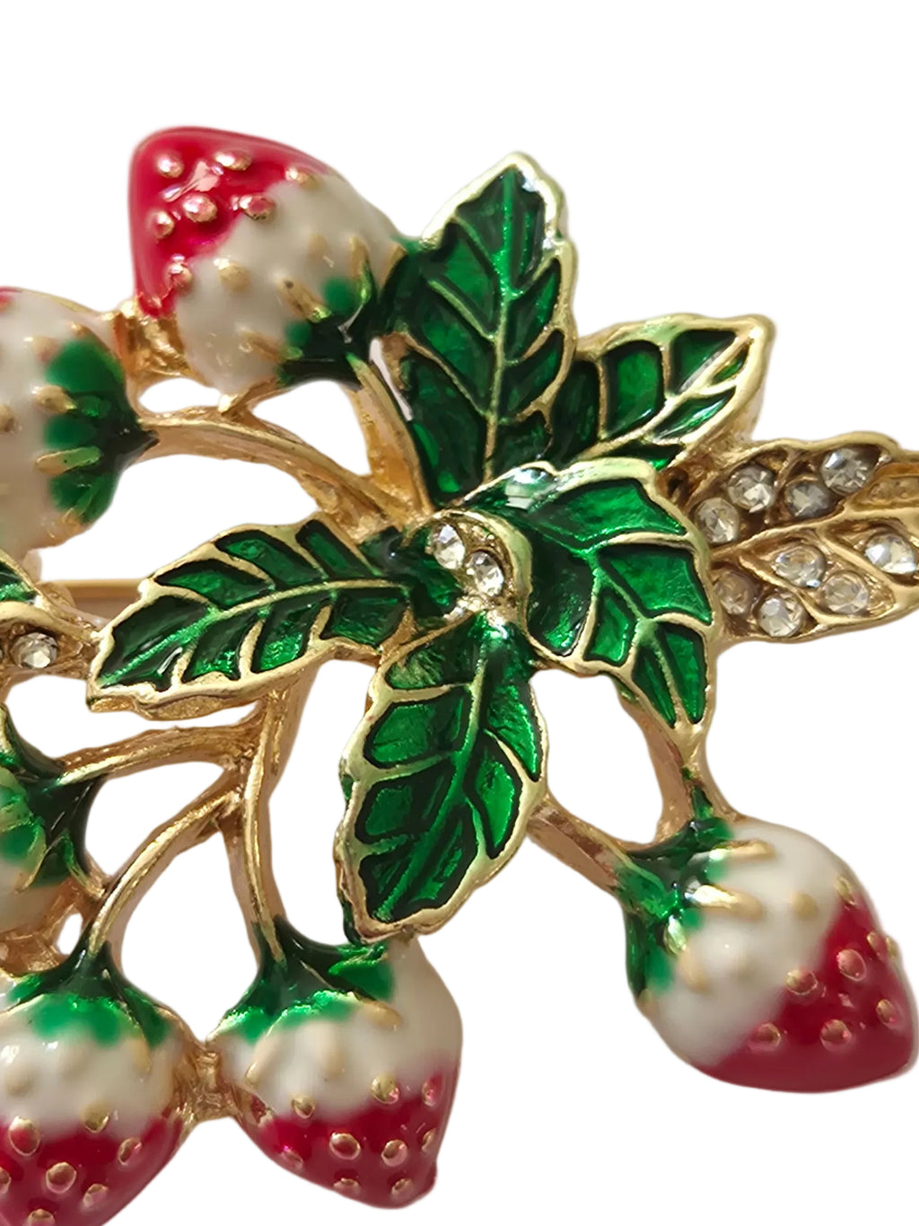 strawberry brooch with green leaves and red berries on a light gray background