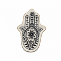 A ceramic Hamsa hand tray with a black floral and botanical handprint design on a white background, finished with a thin gold rim.