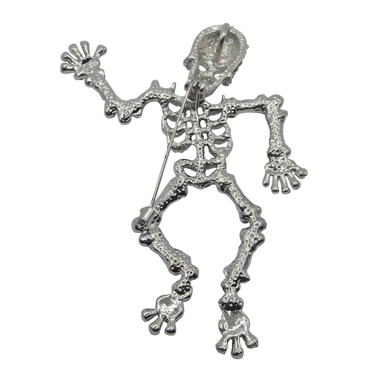 A silver skeleton-shaped brooch showing reverse side with pin mechanism, displayed on a plain white background.