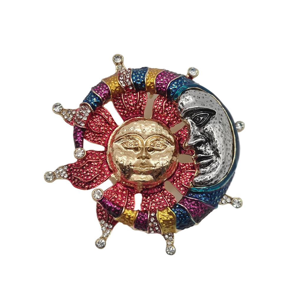 A colorful sun and moon brooch featuring a gold sun face, a silver moon face, and vibrant pink, blue, and purple enamel rays with small clear rhinestone accents, set against a plain white background.