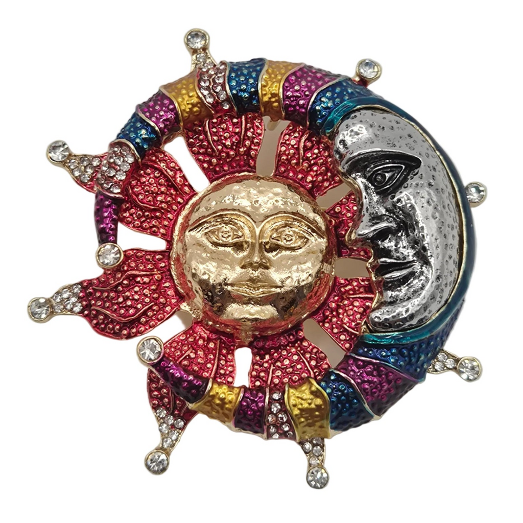 A colorful sun and moon brooch featuring a textured gold sun face, a silver moon face, and multiple colored enamel rays in pink, blue, purple, and gold, accented with clear rhinestones on a white background.