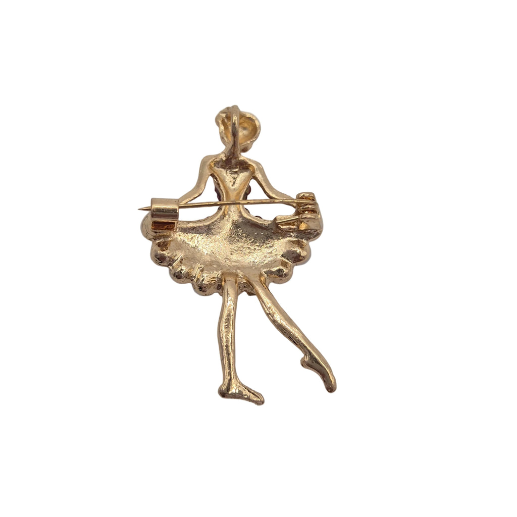 A small gold-toned ballerina figure brooch or pin with a bow and arrow, shown on a plain white background.
