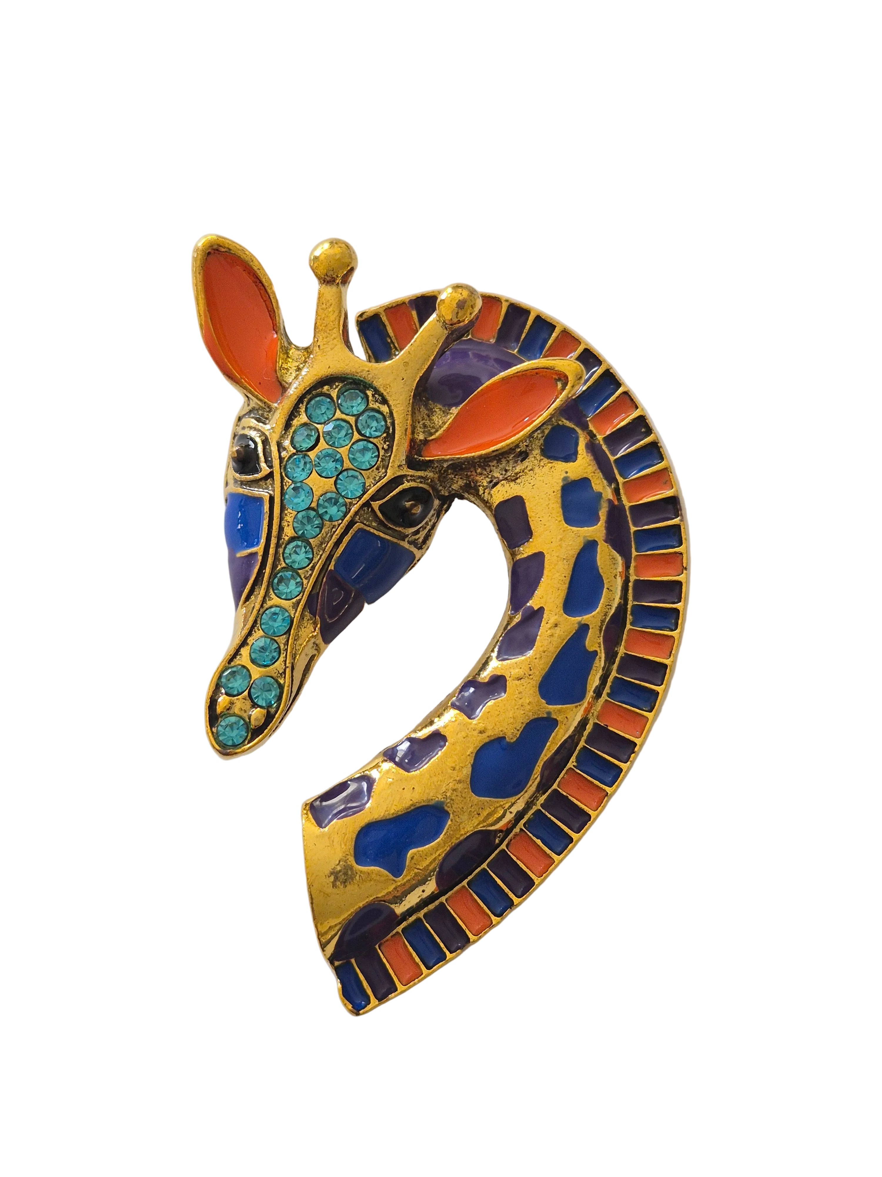Colorful giraffe-shaped brooch with gemstones on a white background