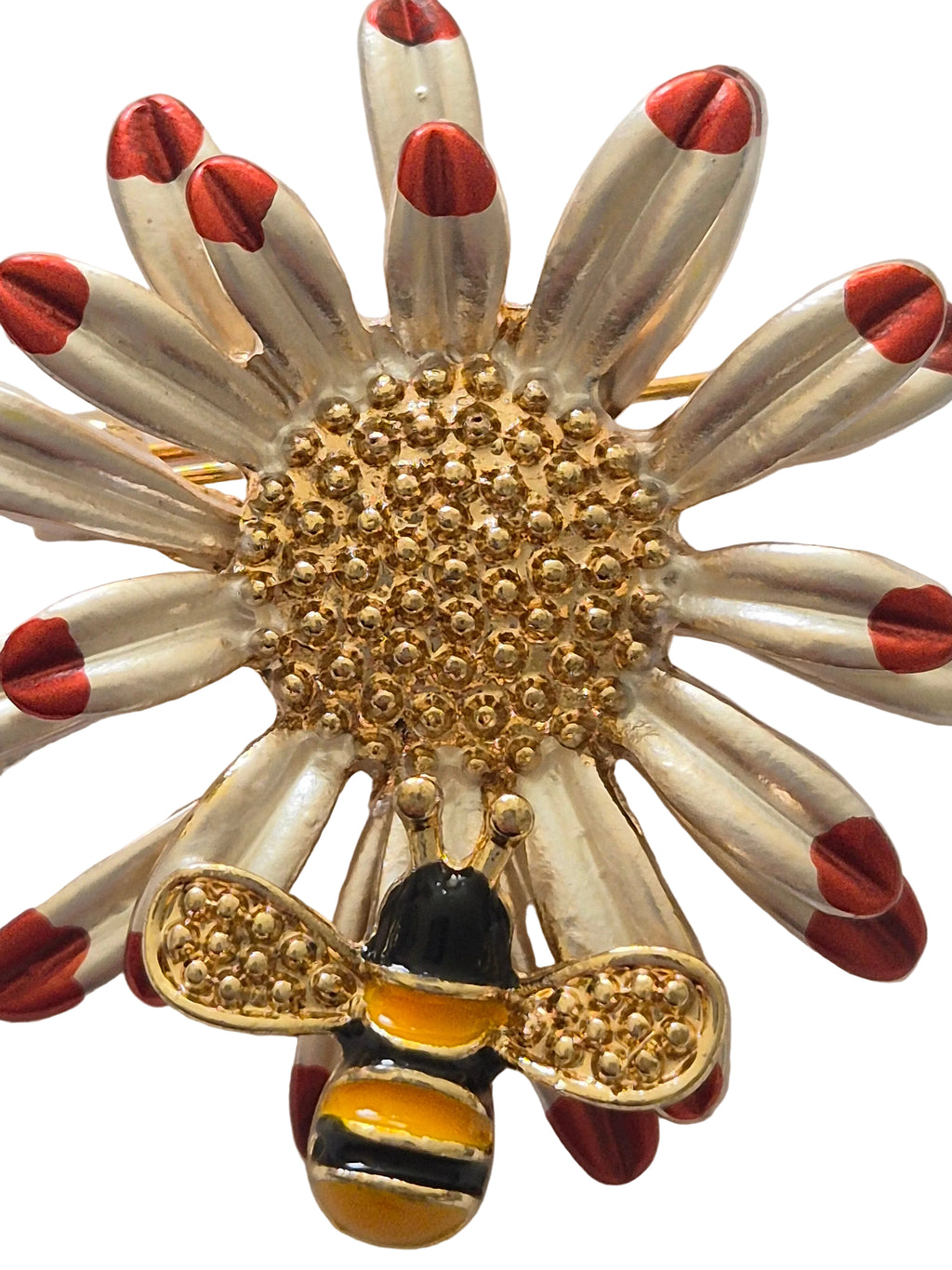 Brooch with a bee and flower design on a white background