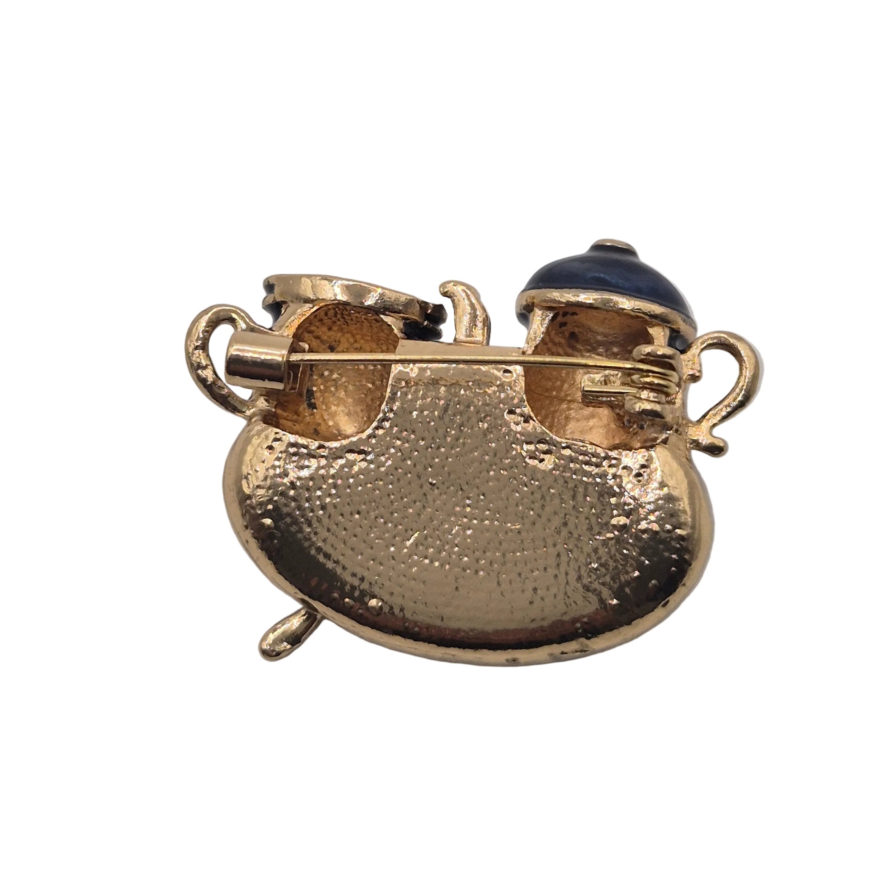 A traditional Turkish style coffee pot and cup with gold-tone accents, displayed on a matching hammered gold tray with a small spoon, isolated on a white background. 