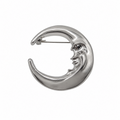 A polished silver crescent moon brooch with a stylized face, shown on a plain white background.