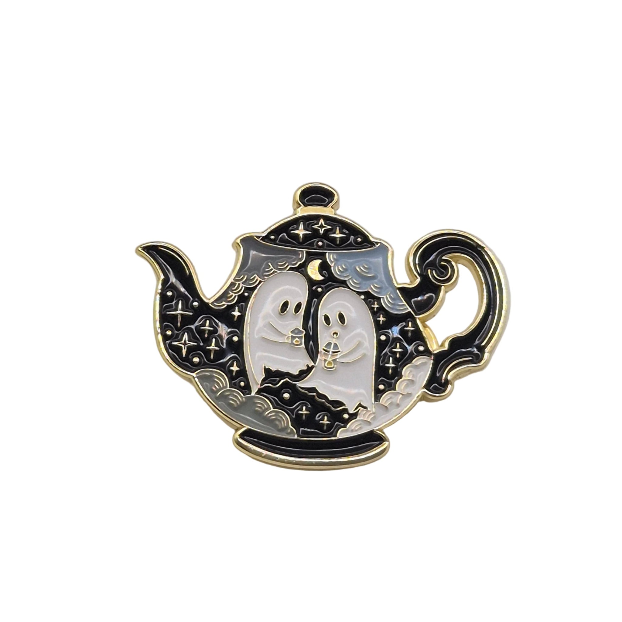 A Halloween-themed enamel pin shaped like a teapot, featuring two white ghosts with black outlines and gold trim against a black and silver patterned background.