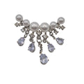 A silver-tone dangle brooch featuring white faux pearls and clear rhinestones, with five teardrop-shaped clear rhinestones hanging from silver chains, set against a plain white background.