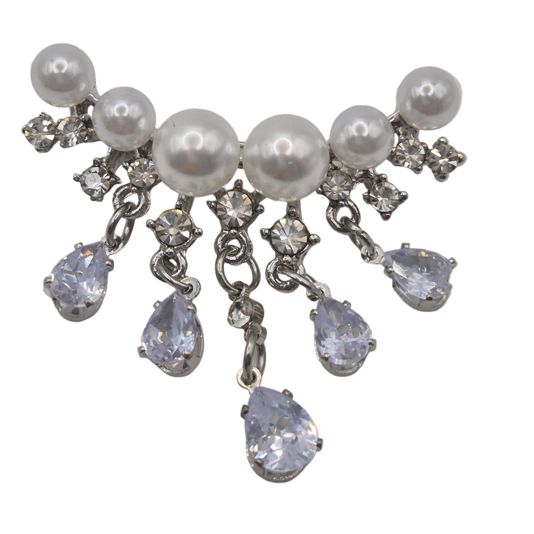 A silver-tone dangle brooch featuring white faux pearls and clear rhinestones, with five teardrop-shaped clear rhinestones hanging from silver chains, set against a plain white background. Shown close up.