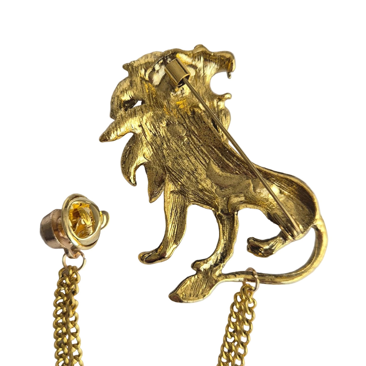 A gold lion-shaped brooch with a matching chain showingreverseside and pin mechanism, photographed on a plain white background.