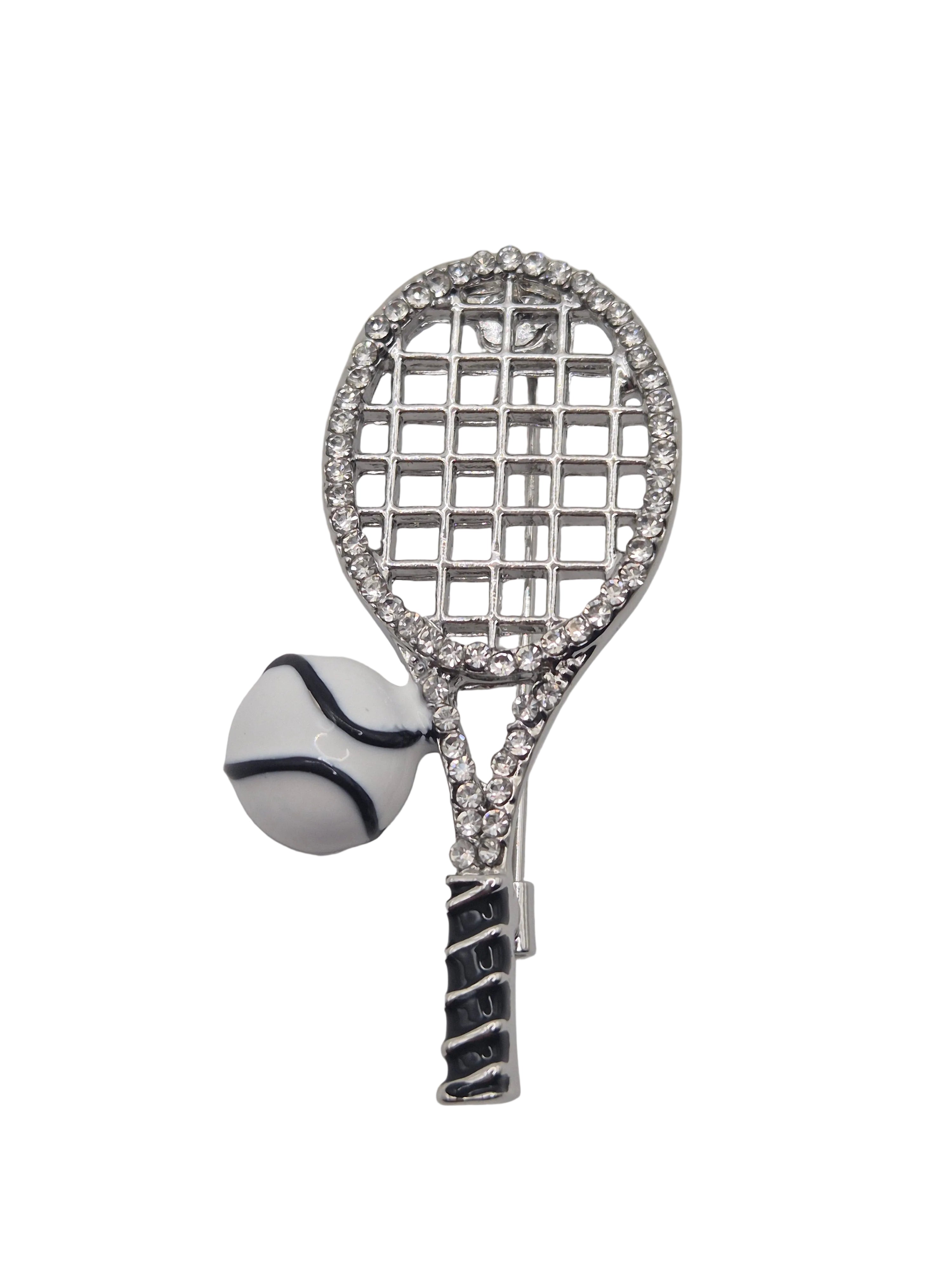 Tennis racket and ball brooch with rhinestone details on a white background