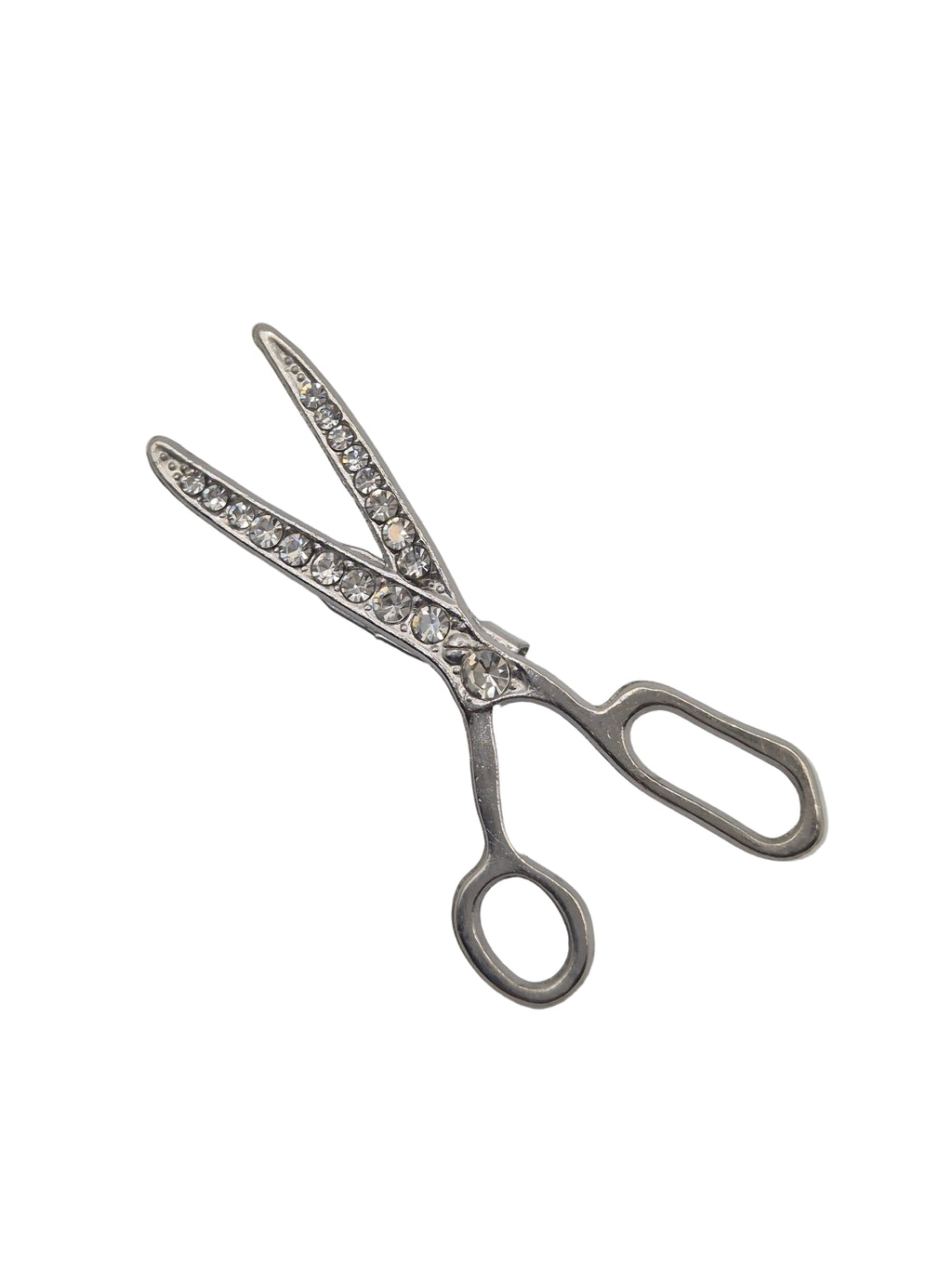 Silver scissors brooch with gemstone accents on a white background