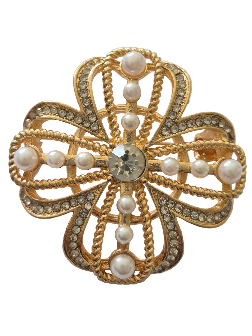 Pearl four-leaf clover brooch with central gemstone on a light gray background,