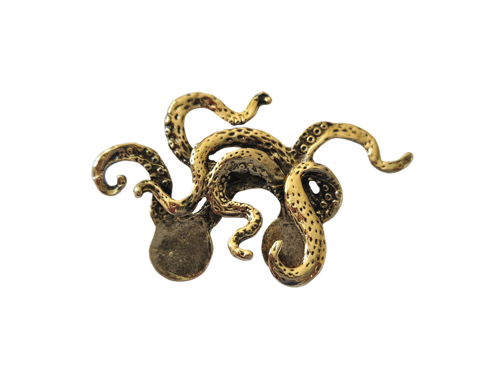 Gold octopus-shaped brooch on a light gray background