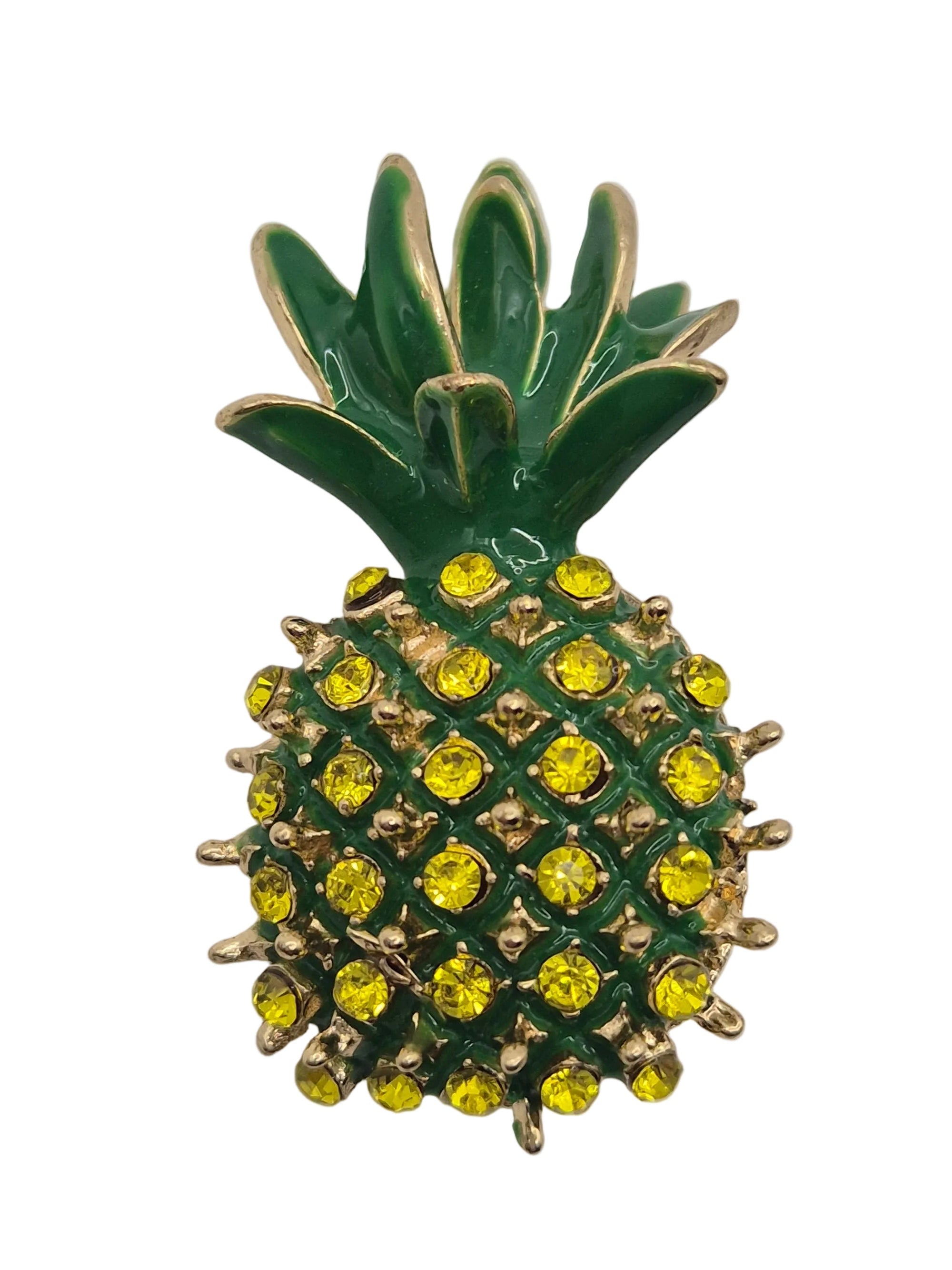 Pineapple shaped brooch with green body and yellow gemstones on a white background