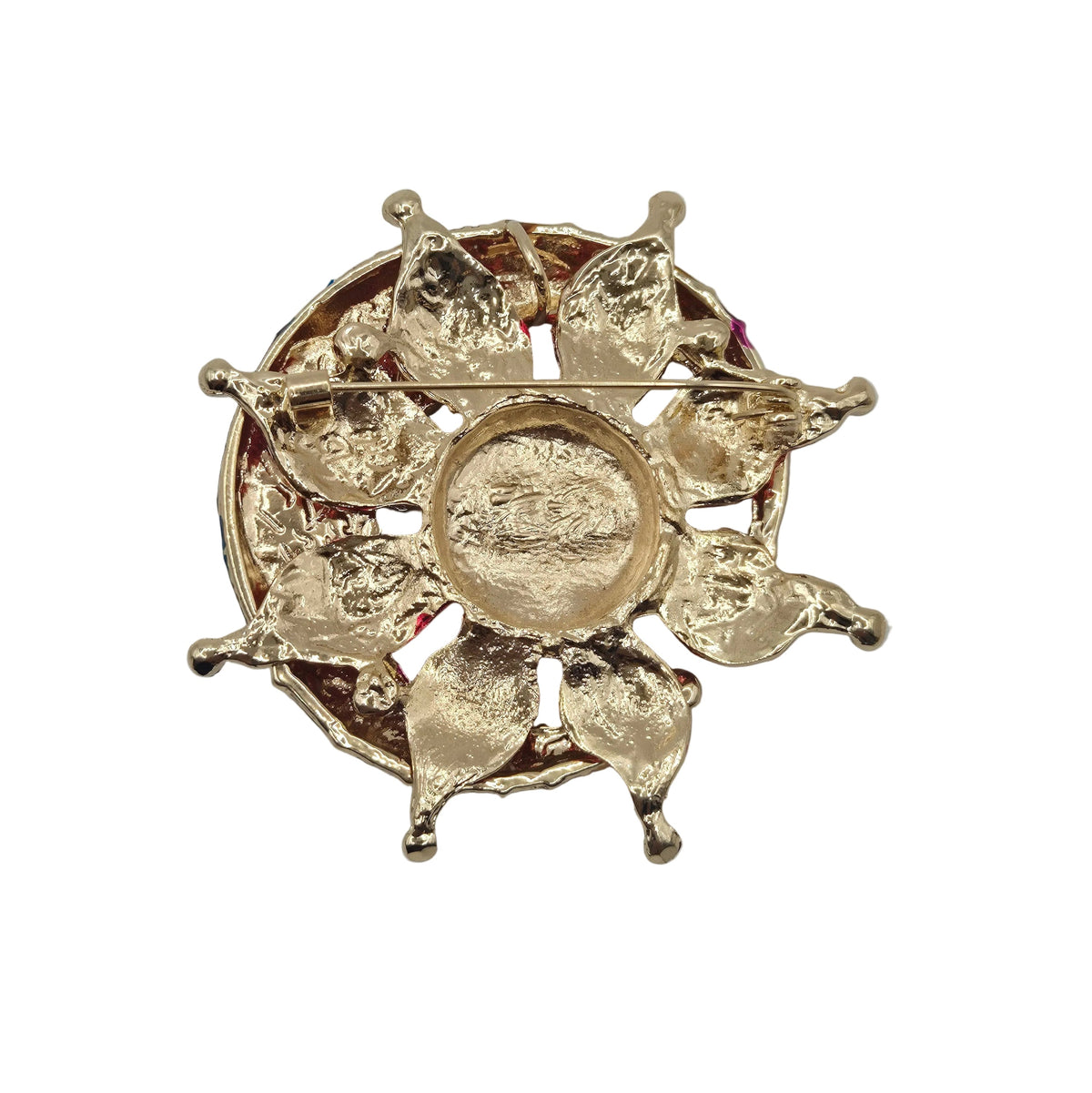 A gold-toned circular brooch with a sunburst design, photographed from above on a plain white background.