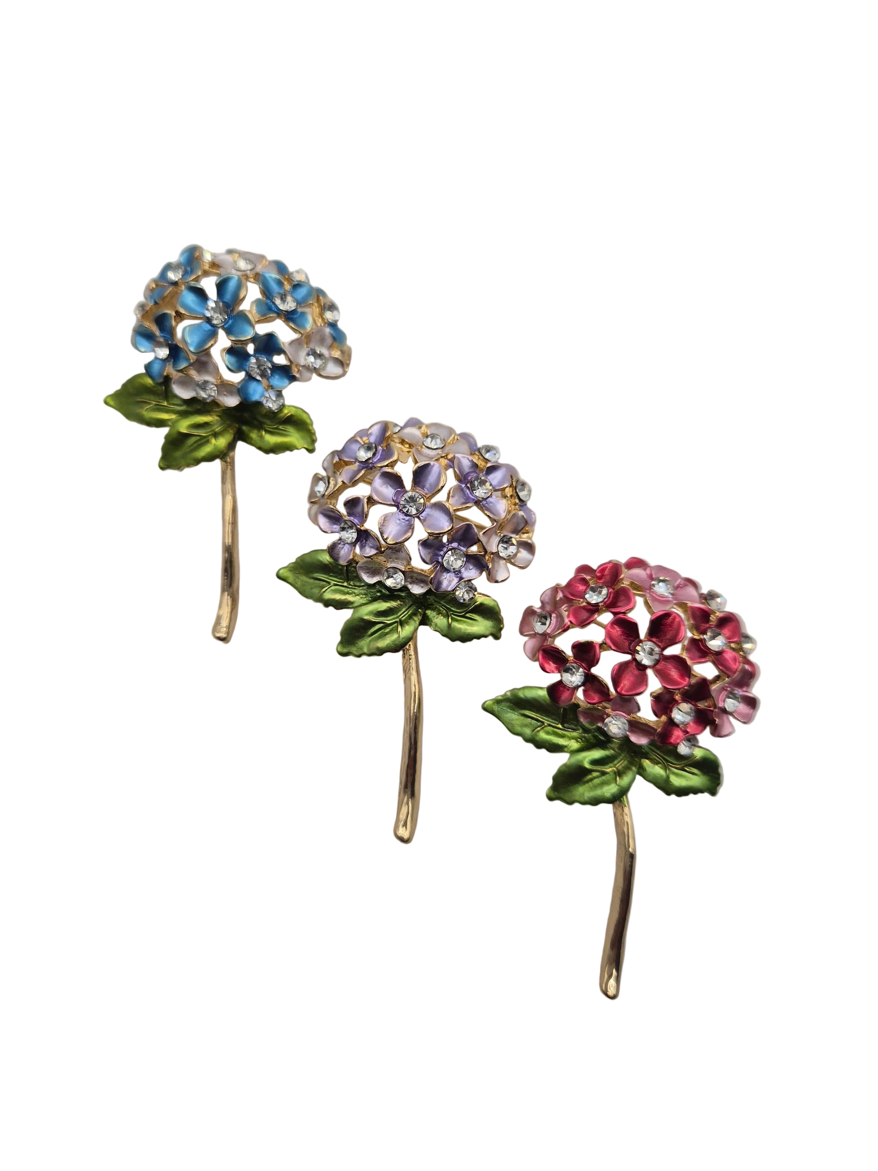 floral brooch gemstone-like decorations on a gray background