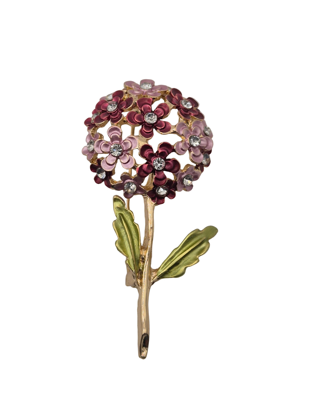 A gold-tone floral brooch featuring a round cluster of small flowers in pink, burgundy, and rose gold with clear rhinestone centers, and two green enamel leaves on a stem, shown on a plain white background.