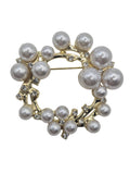 Circular brooch with pearls on a light gray background